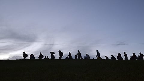 German federal police officers guide a group of migrants on their way after crossing the border between Austria and Germany in Wegscheid near Passau, Germany. (File Photo | AP)