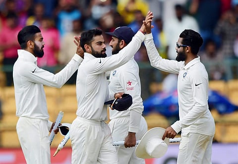 Indian captain Virat Kohli celebrates with team mates after beating Australia in the second test match at Chinnaswamy stadium in Bengaluru on Tuesday. | PTI