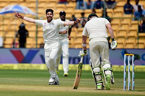 Umesh Yadav celebrates the wicket of Steve Smith during the fourth day of the second test match between India and Australia at Chinnaswamy stadium in Bengaluru on Tuesday. | PTI