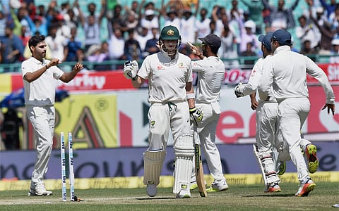 India's Bhuvneshwar Kumar celebrates the wicket of Australia's Steve Smith during the 3rd day of last test match at HPCA Stadium in Dharamsala on Monday. | PTI