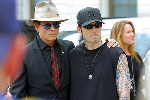 Actor Johnny Depp, left, stands with former Arkansas death row inmate Damien Echols, before speaking at a rally opposing Arkansas' upcoming executions, which are set to begin next week, on April 14. (Photo | AP)