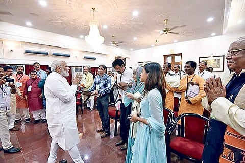PM Narendra Modi greets kin of the freedom fighters at Raj Bhawan in Bhubaneswar on Sunday