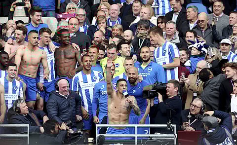 Brighton and Hove Albion's Anthony Knockaert centre, leads the celebrations as players and fans celebrate promotion, following the EFL Championship match between Brighton and Wigan Athletics, at the AMEX Stadium, in Brighton. | AP