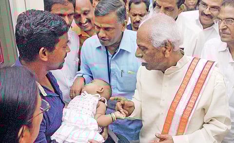 Union Minister Bandaru Dattatreya interacting with a young father at the ESI Hospital, Pathalam, on Monday | K Shijith