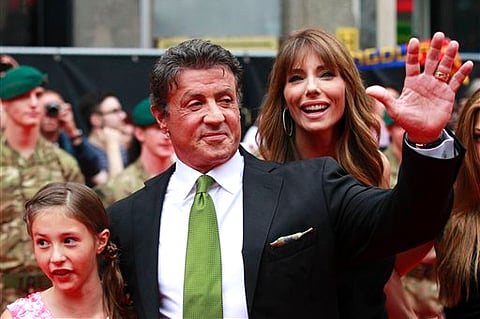 Cast member actor Sylvester Stallone poses with his family as he arrives for the UK premiere of 'Expendables 2' in London (File | AP Photo/Sang Tan).