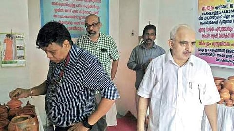 State Police Chief Loknath Behera looking at wares on display at Sathyam store. Sathya Sai Trust executive director KN Anandakumar is also seen