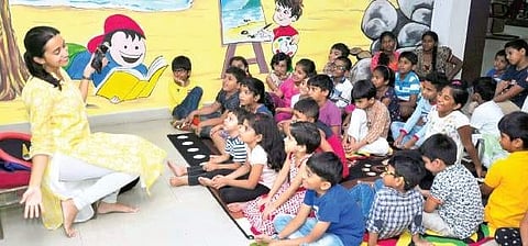 Priya Uppalapati narrates a story while children enjoy during a storytelling session organised at JustBooks in Visakhapatnam on Saturday, on the eve of the World Book Day | Express