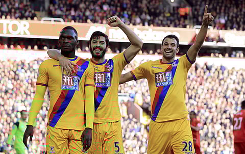 Crystal Palace's Christian Benteke, left, celebrates scoring against Liverpool with teammates during the English Premier League soccer match at Anfield, Liverpool, Sunday April 23, 2017. | AP