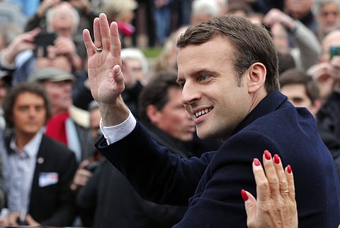 Centrist candidate Emmanuel Macron waves supporters after casting his vote in the first round of the French presidential election, in le Touquet, northern France, Sunday April 23, 2017. | AP