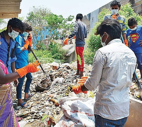 Youth cleaning up the garbage.