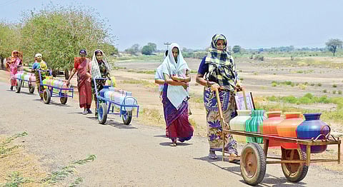 Women pushing carts carrying filled water pots in Mudukulathur | Alagu