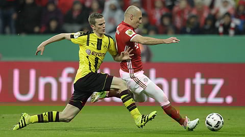 Dortmund's Sven Bender, left, and Bayern's Arjen Robben challenge for the ball during the German Soccer Cup semifinal match between FC Bayern Munich and Borussia Dortmund at the Allianz Arena stadium in Munich. | AP