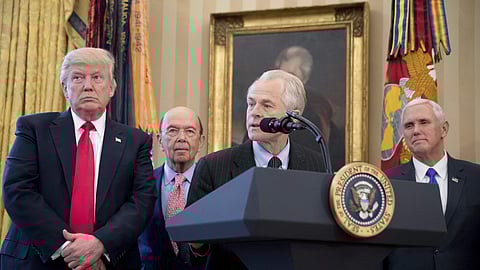 National Trade Council adviser Peter Navarro, second from right, accompanied by President Donald Trump.
