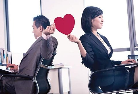 When love blooms in an office cubicle, should you hide it?