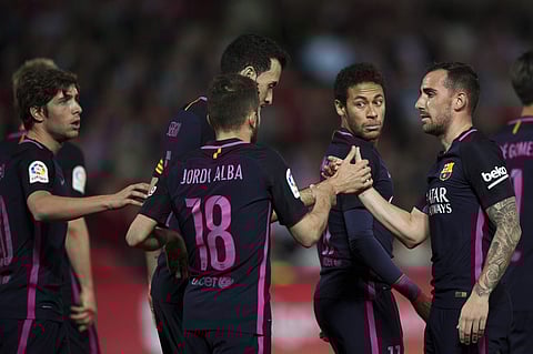 FC Barcelona's Paco Alcacer, right, celebrates his goal with teammates during a Spanish La Liga soccer match between Granada and Barcelona in Granada, Spain, Sunday, April 2, 2017. | AP