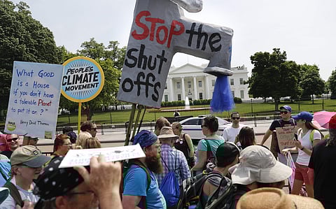 Participants walk along Pennsylvania Ave., in front of the White House in Washington, during a demonstration and march, Saturday, April 29, 2017. | AP