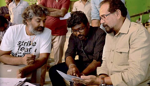 Director SS Rajamouli L and Production Designer Sabu Cyril R in a discussion with Concept artist Viswanath Sundaram on the sets of film 'Baahubali' in Chennai on Tuesday.(Photo | PTI)
