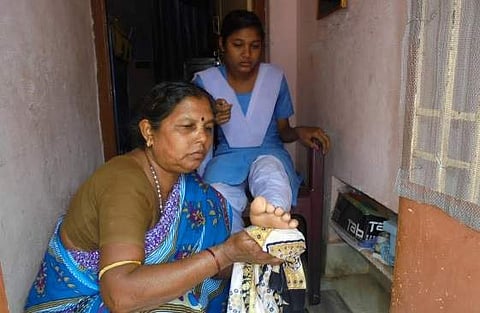 Sujata Kausalya’s mother providing cold water treatment to her daughter’s feet | Express