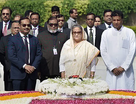 Bangladesh Prime Minister Sheikh Hasina paying tribute at Mahatma Gandhi's memorial Rajghat in New Delhi on Saturday. | PTI