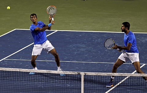 India's Rohan Bopanna right watches his partner Sriram Balaji return a shot to Uzbekistan's Farrukh Dustov and Sanjar Fayziev during their Davis Cup tennis Asia-Oceania second round tie between India and Uzbekistan in Bengaluru on Saturday. | PTI