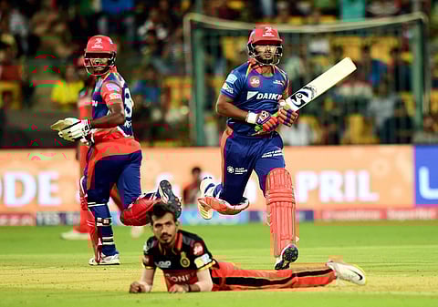Delhi Daredevils Rishabh Pant and Sanju Samson runs for a single run as Yuzvendra Chahal on the ground during the IPL 10 match against Royal Challengers Bangalore at Chinnaswamy stadium in Bengaluru on Saturday. | PTI