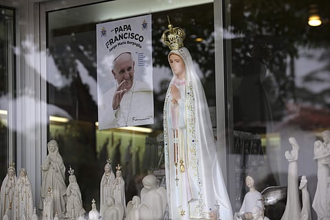 A photo of Pope Francis, Francisco in Portuguese, is displayed on the window of a shop selling statues of Our Lady of Fatima in the village of Fatima, Portugal. (File|AP)