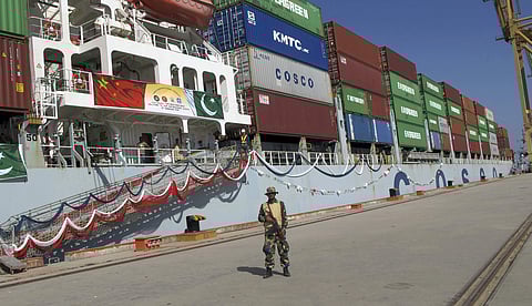 A Pakistan Navy soldier stands guard while a loaded Chinese ship prepares to depart from Gwadar port that links to China's far western region on a new international route exporting goods to the Middle East and Africa. (File photo | AP)