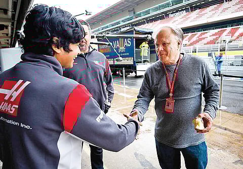 Arjun Maini is greeted by Haas Formula 1 team owner Gene Haas