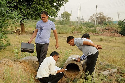 Forensic experts inspecting the scene of crime where the brutally mutilated body of a woman was dumped after she was abducted gang-raped and murdered in Rohtak on Sunday. | PTI