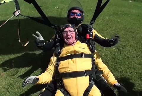 In this grab taken from video, Verdun Hayes lands after a tandem skydive, in Devon, England. (AP)