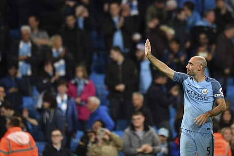 Manchester City's Argentinian defender Pablo Zabaleta takes the applause of the crowd in tribute for his final home appearance for the club at the end of the English Premier League football match between Manchester City and West Bromwich Albion at the Eti