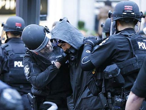 Seattle Police officers make an arrest, Monday, May 1, 2017, during a May Day protest in Seattle. (AP Photo)