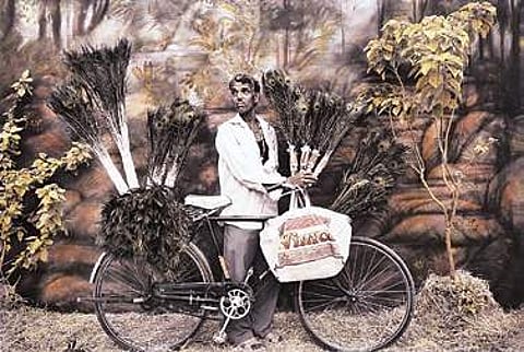 © Waswo X. Waswo, Feathers for Sale, 2008, Black and white pigment print hand-coloured by Rajesh Soni Courtesy Tasveer