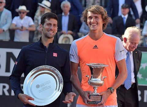 Alexander Zverev of Germany (R) poses with the trophy after winning the ATP Tennis Open final against Novak Djokovic (L) of Serbia on May 21, 2017, at the Foro Italico in Rome. AFP