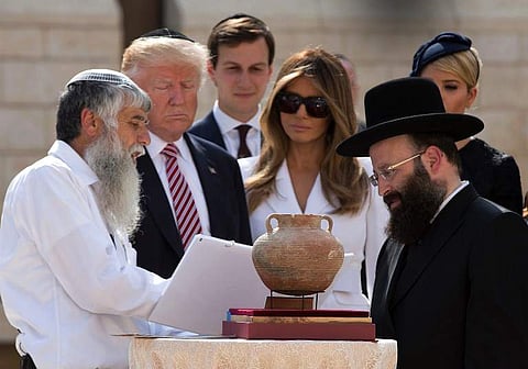 US President Donald Trump (2nd L), senior advisor Jared Kushner (3rd L), first lady Melania Trump (C) and Ivanka Trump, the president's daughter, listens to Rabbi Shmuel Rabinovitch (R) during a visit to the Western Wall, the holiest site where Jews can p