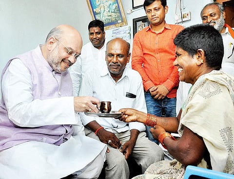 BJP national president Amit Shah having tea at a house in Peddadevulapally village of Thripuraram mandal in Nalgonda district on Tuesday | Express photo
