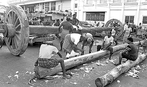Chariot construction work in progress along the grand road in Puri on Tuesday | Express