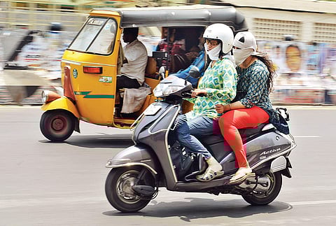 Two girls on a two-wheeler despite the hot summer afternoon in Chennai, on Wednesday | Express File Photo