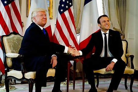 U.S. President Donald Trump shakes hands with French President Emmanuel Macron at the US ambassador's residence in Brussels, Thursday, May 25. (Photo | AP)