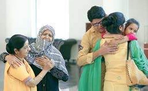 (Right) Uzma Ahmed is welcomed by family, while Union Minister Sushma Swaraj consoles one of the family members in New Delhi on Thursday| Shekhar yadav