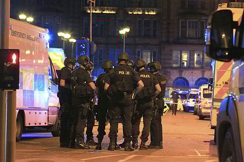 Armed police and ambulance services at the suspected terrorist attack site in Manchester Arena on Tuesday. (AP)