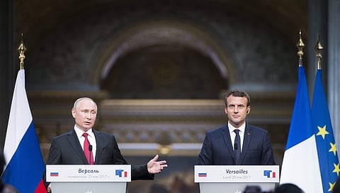 French President Emmanuel Macron, right, and his Russian counterpart Vladimir Putin hold a joint press conference at the Palace of Versailles as they meet for talks before the opening of an exhibition marking 300 years of diplomatic ties between the two c