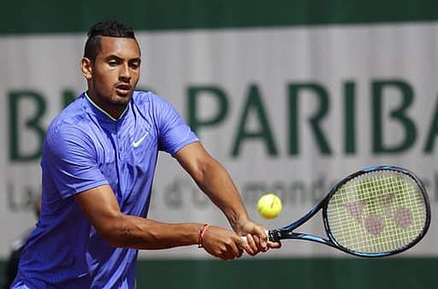 Australia's Nick Kyrgios returns the ball to Germany's Philipp Kohlschreiber during their first round match of the French Open tennis tournament at the Roland Garros stadium. | AP