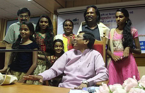 Union Minister Sudarshan Bhagat interacting with K V Karthikeyan, his wife K C Rekha and their family members during a function organised by the CMFRI to honour them in Kochi on Friday | Melton Antony