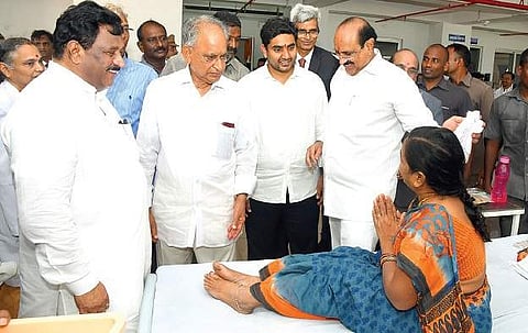 IT minister N Lokesh interacts with patients at GIMSR Hospital on Saturday as minister K Srinivasa Rao and GITAM president MVVS Murthi look on | Express