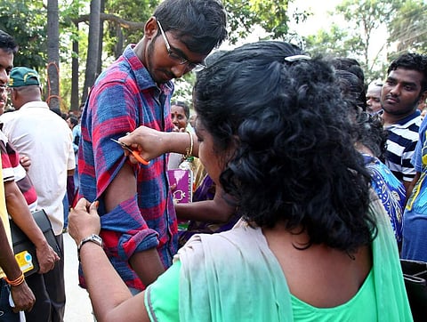Sleeves of students being cut off before enetering the NEET exam centre in Chennai. (Romani Agarwal | EPS)