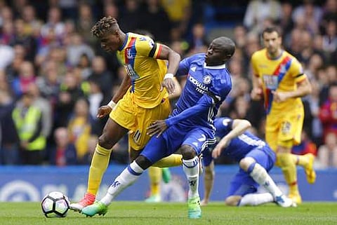 Chelsea's N'Golo Kante, right, vies for the ball with Crystal Palace's Wilfried Zaha during the English Premier League soccer match between Chelsea and Crystal Palace at Stamford Bridge stadium in London Saturday, April 1, 2017.(Photo | AP)