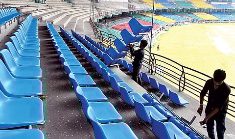 Workers engaged in fixing new chairs at the Jawaharlal Nehru International Stadium gallery as part of the renovation work for the FIFA U-17 World Cup in Kochi on Sunday | Melton Antony