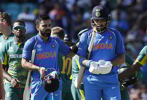 India's captain Virat Kohli, left, and India's Yuvraj Singh leave the pitch with South Africa's players after the ICC Champions Trophy match between India and South Africa at The Oval cricket ground in London, Sunday, June 11, 2017. | AP
