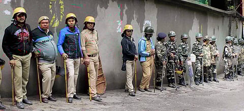 Security personnel stand guard during a strike called by Gorkha Janmukti Morcha in Darjeeling Hills on Monday. | PTI